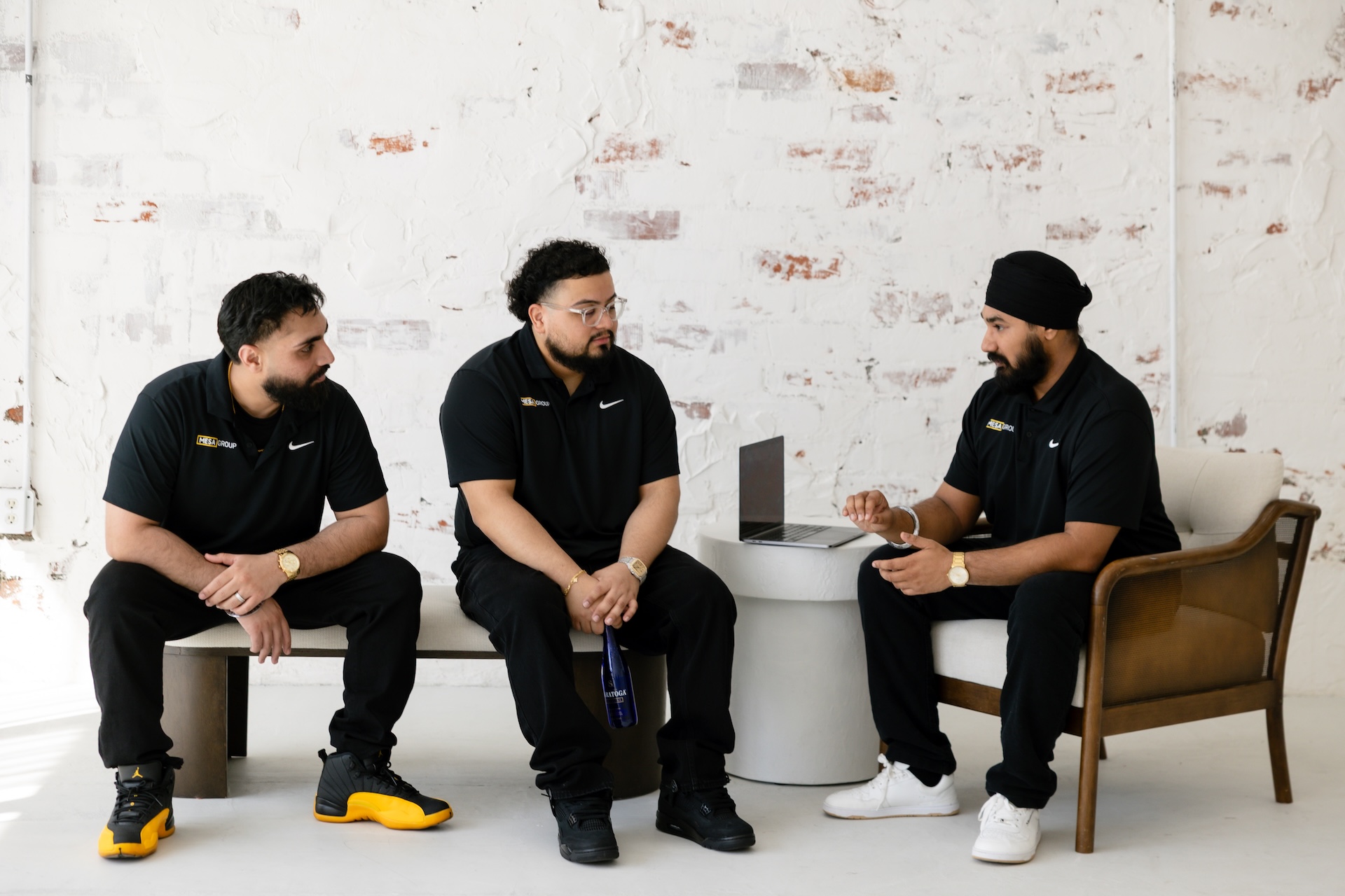 Mesa Group Consulting team in an animated strategy discussion, Gurtej Singh gesturing with Evert Calderon and Harpreet Moore